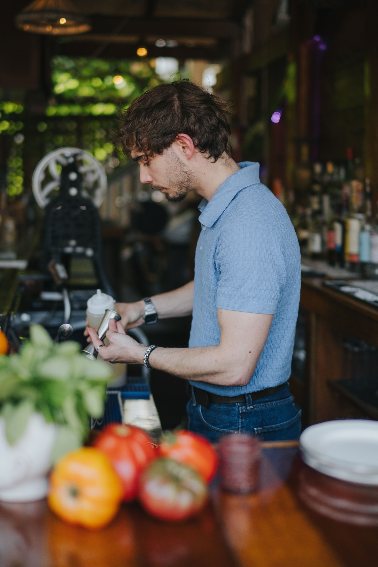 Bartender building a cocktail behind the bar