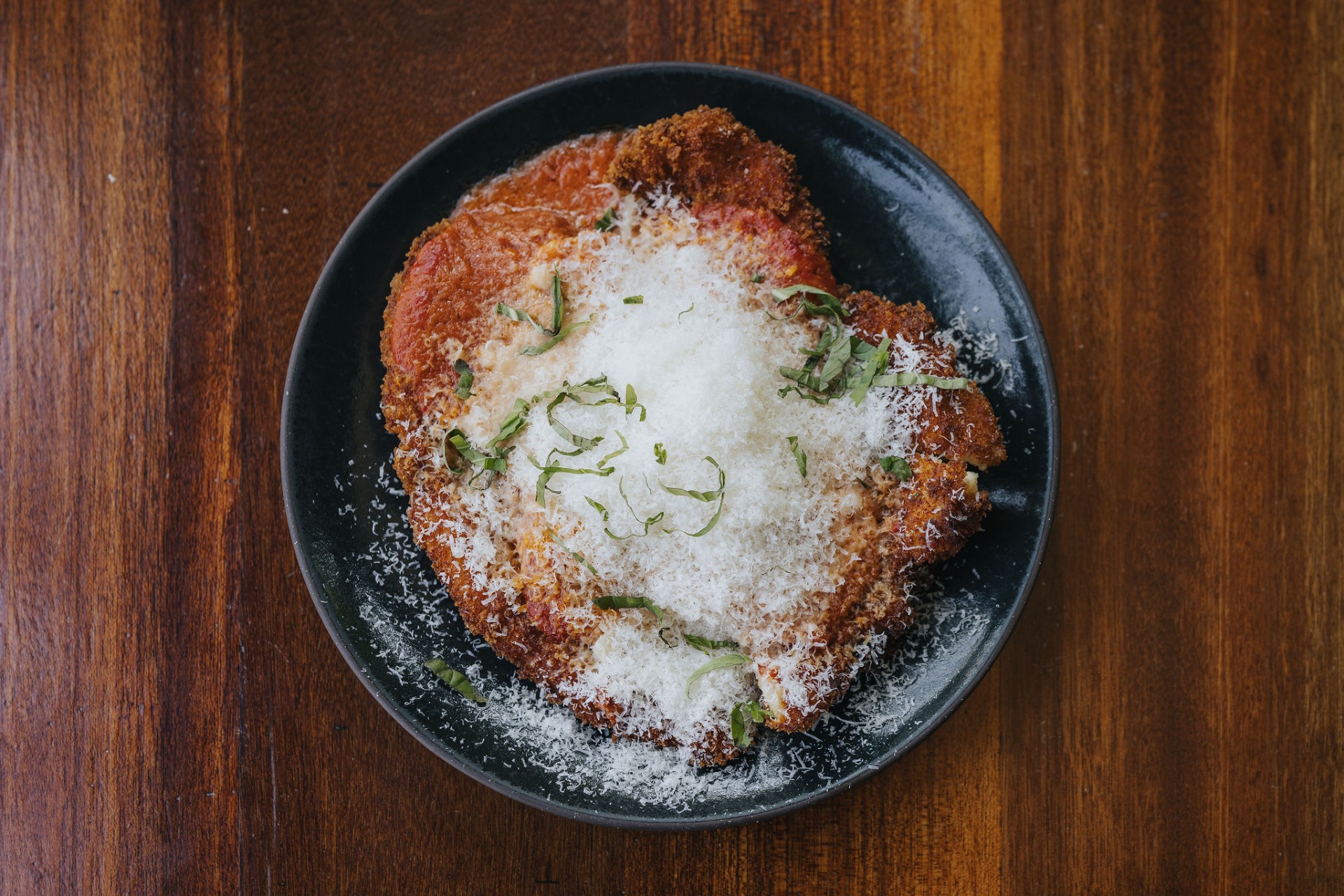 Crispy chicken parm with tomato sauce and fresh parmesan