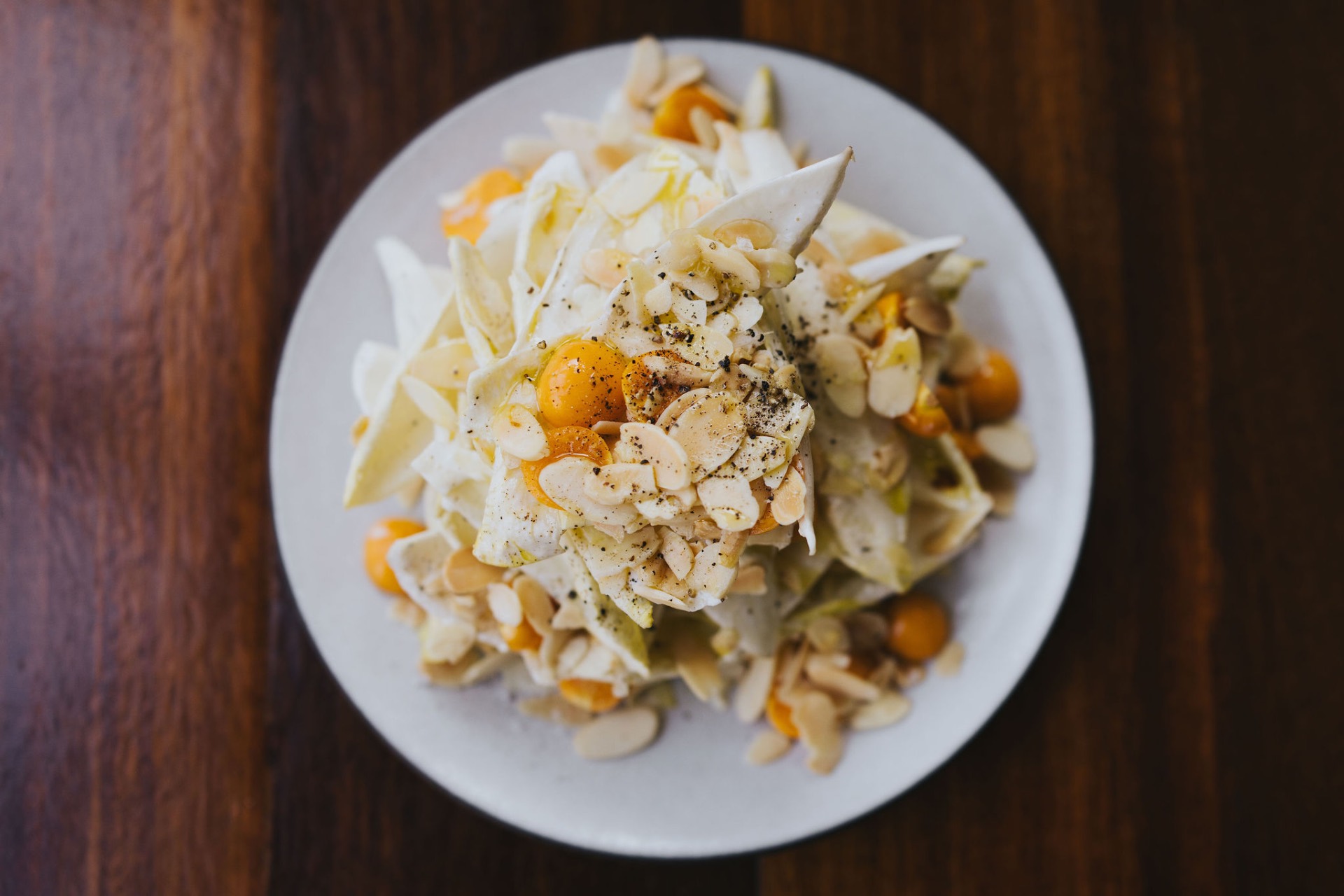 Endive salad with goldenberries, shaved almonds, and black pepper
