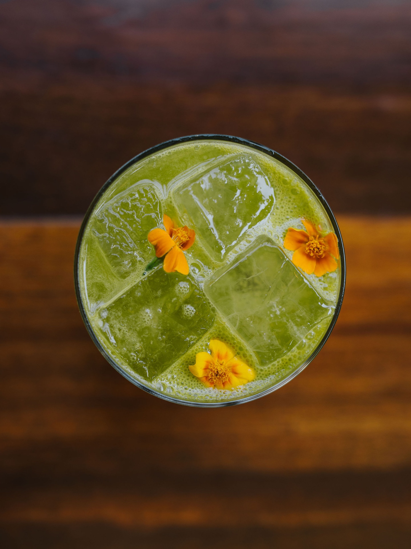 Garden cocktail with marigold flowers, overhead
