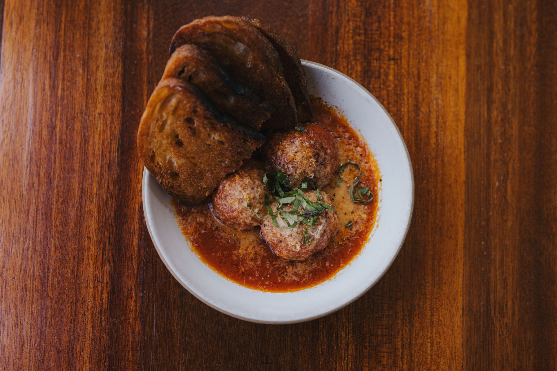 House meatballs in tomato sauce with grilled sourdough