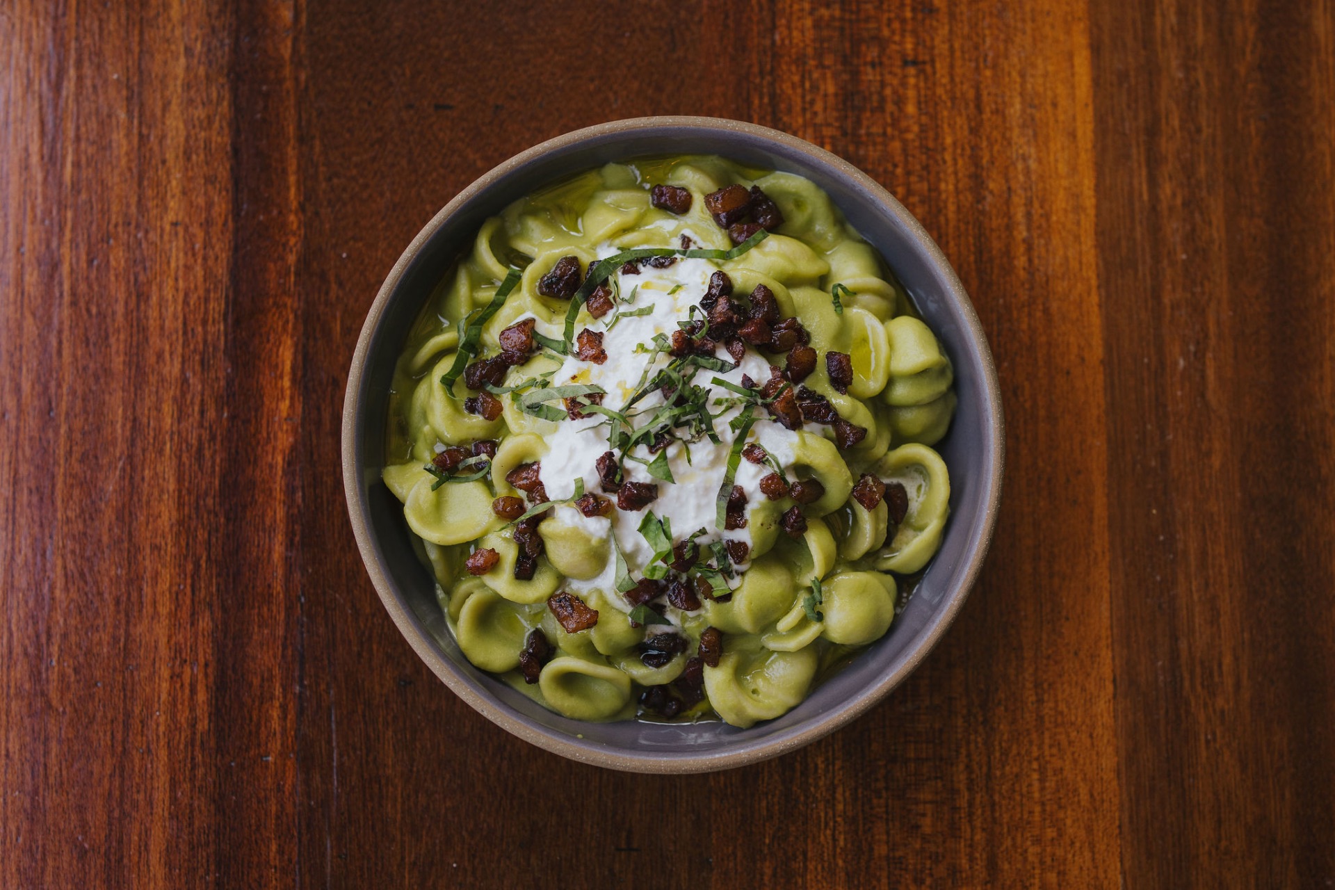 Orecchiette in pesto with ricotta, pancetta, and basil