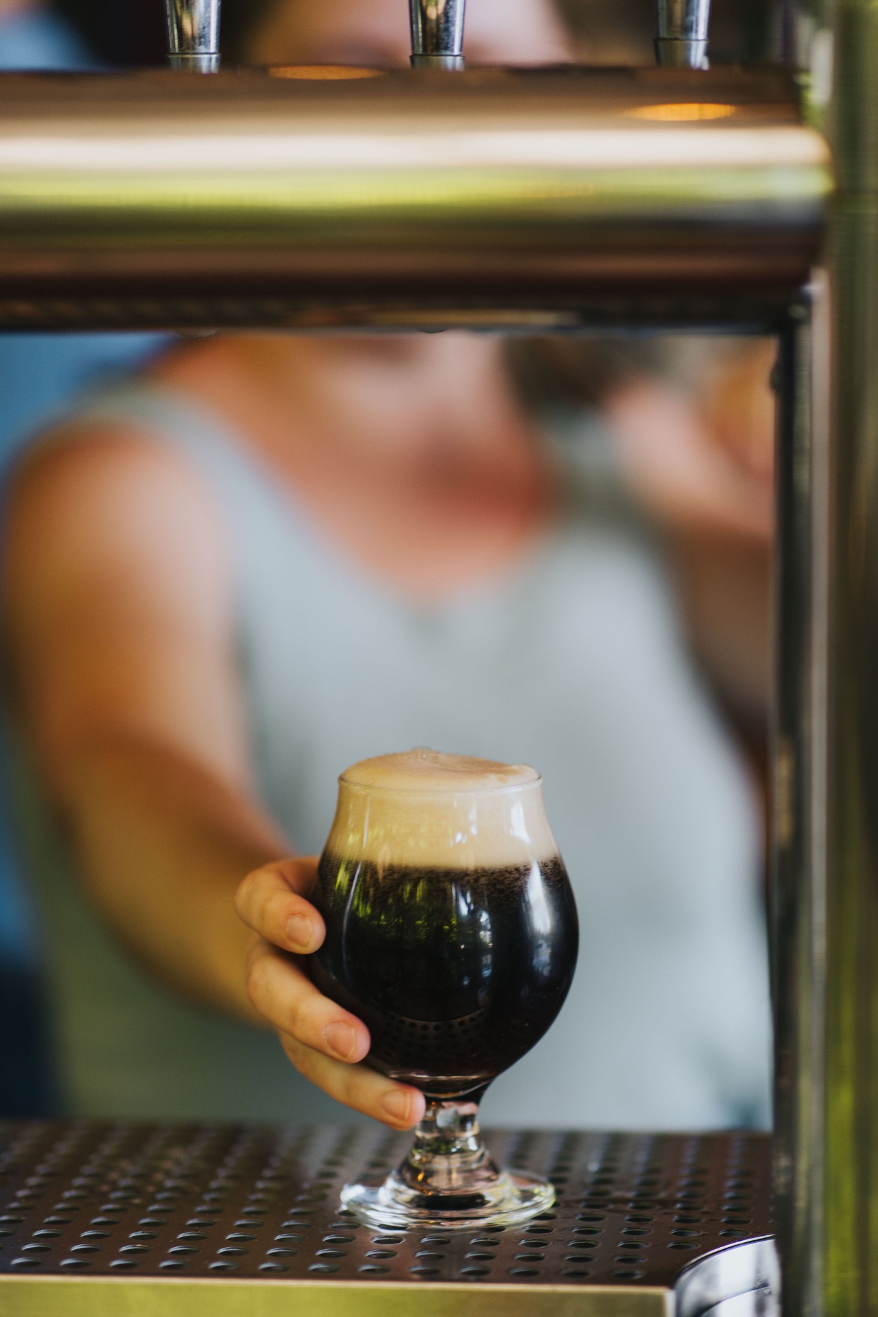 Bartender handing over a freshly pulled nitro stout